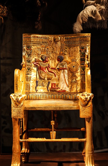 Image displaying the golden throne of Tutankhamun on a black background